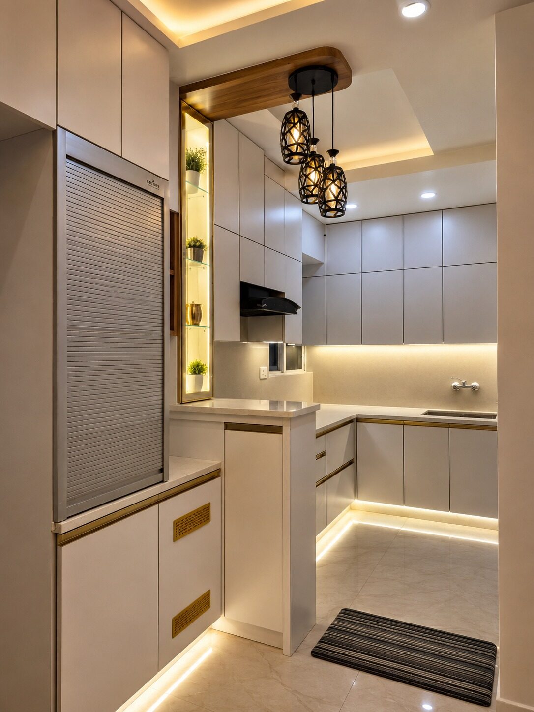Finished modular kitchen with white cabinetry, gold trim and pendant lighting