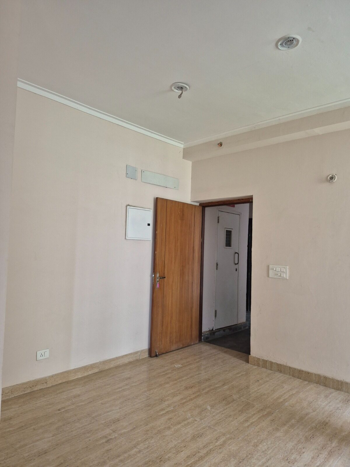 Empty plastered room before interior work, bare floor and single door