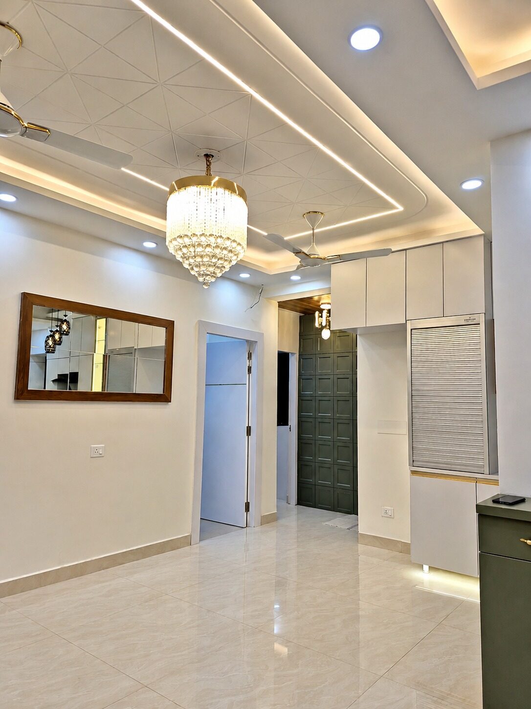 Finished entrance passage with mirror, chandelier and fitted storage