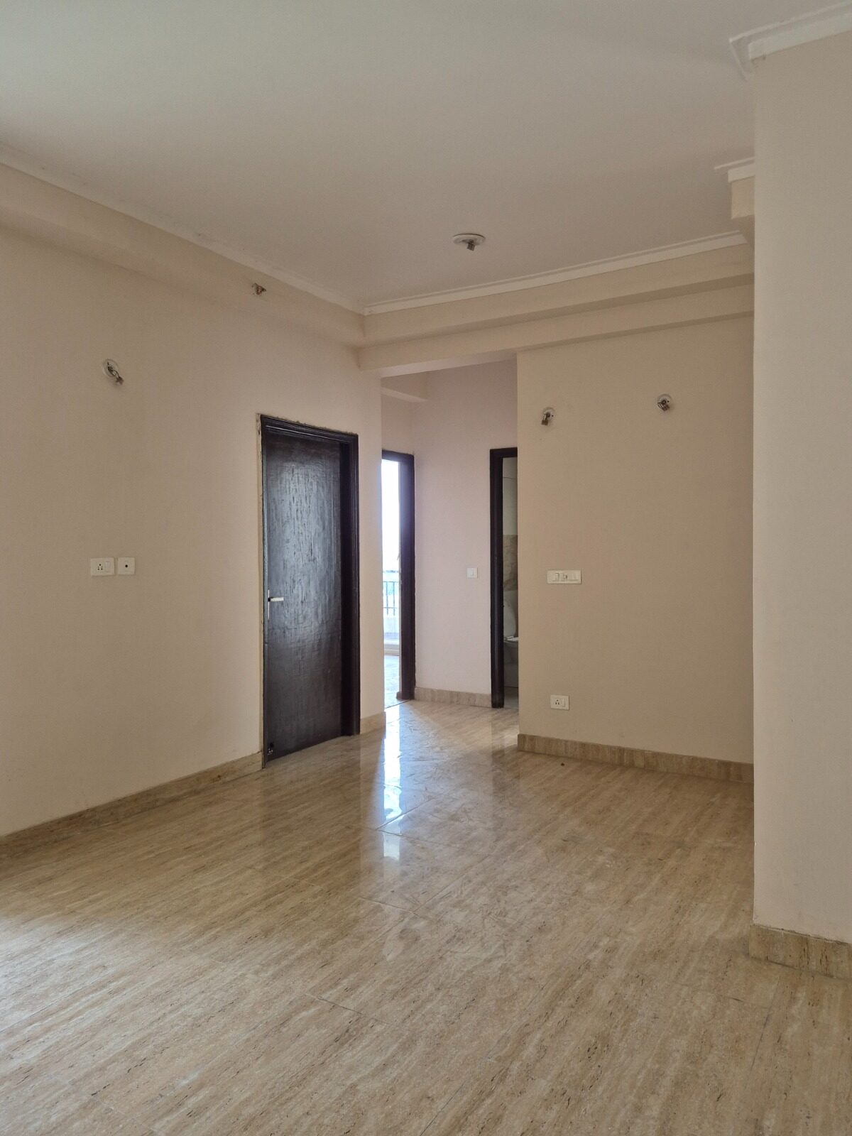 Unfinished room with multiple doors before interior work