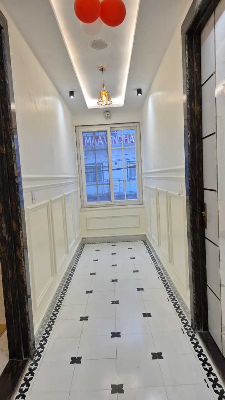 Hotel corridor with panelled walls and patterned marble flooring
