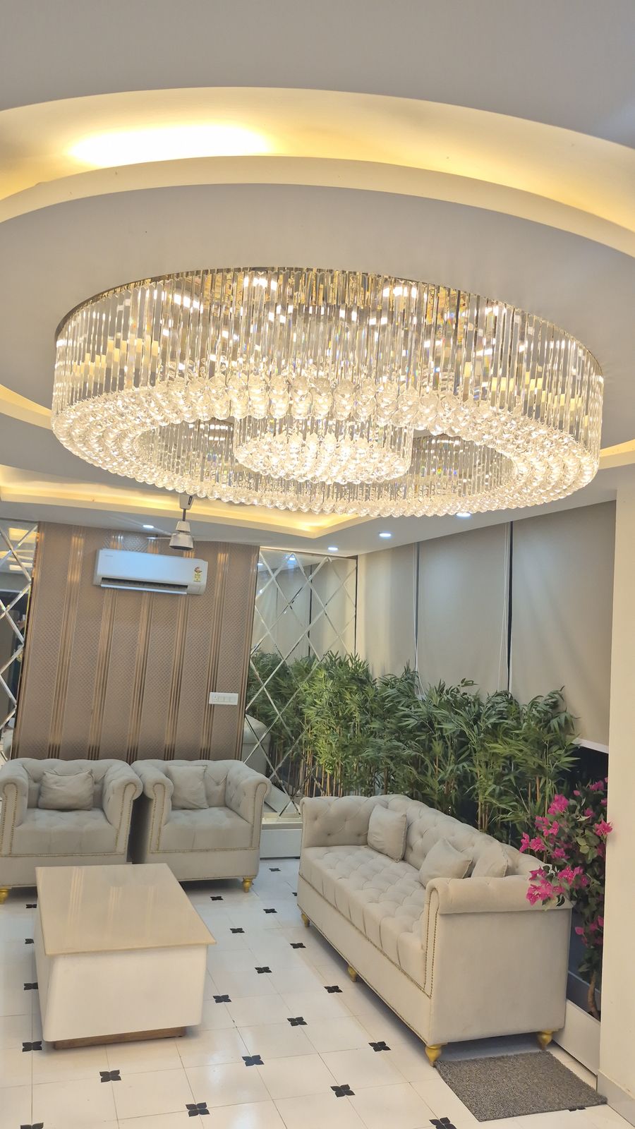 Hotel lobby with a carved timber arch and chandelier