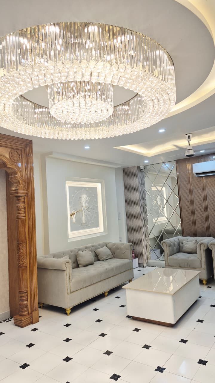Hotel lobby with a tiered crystal chandelier and circular ceiling detail