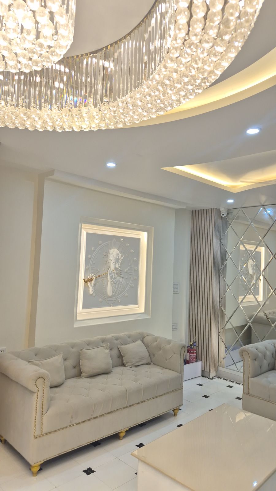 Hotel reception lounge with sofas and a mirrored feature wall