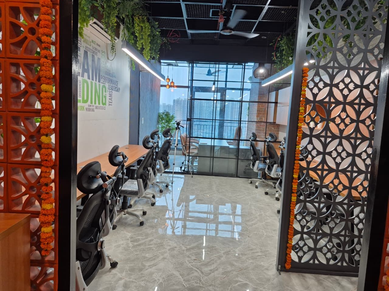Working desks framed by a terracotta jaali screen partition
