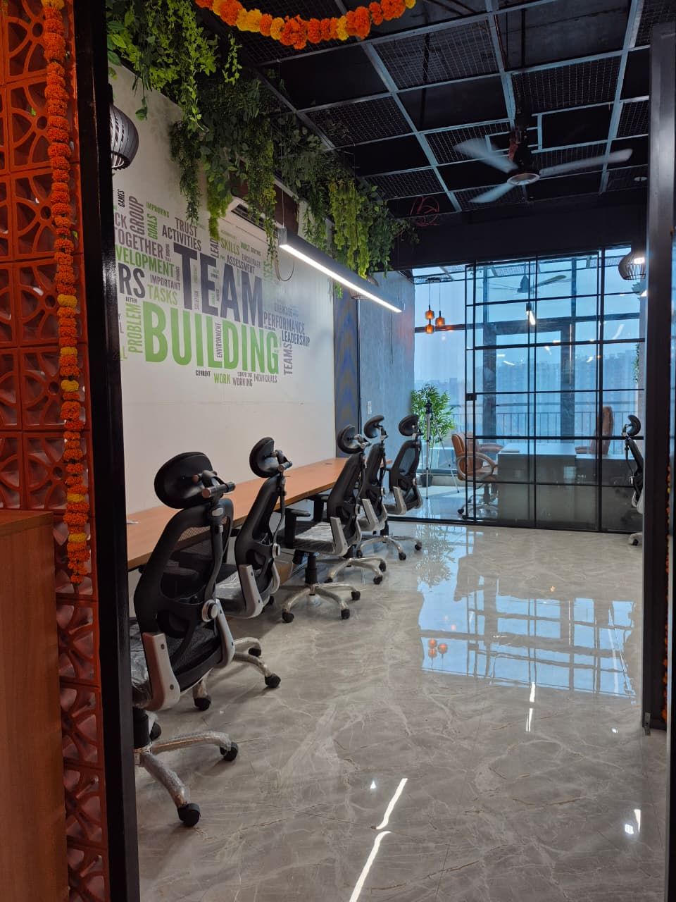 Terracotta jaali partition dividing the workspace