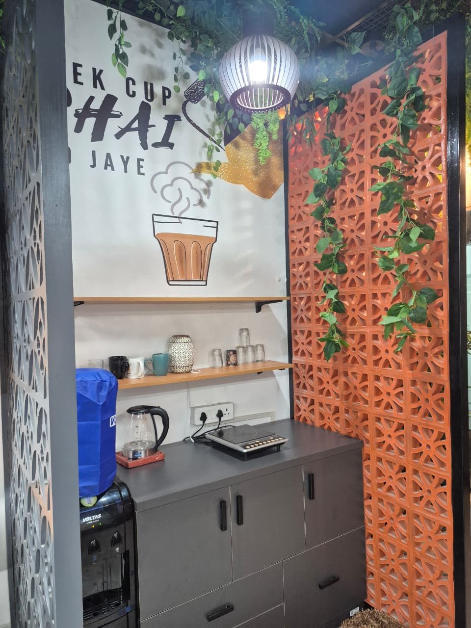 Office pantry with cabinetry, counter and a jaali screen