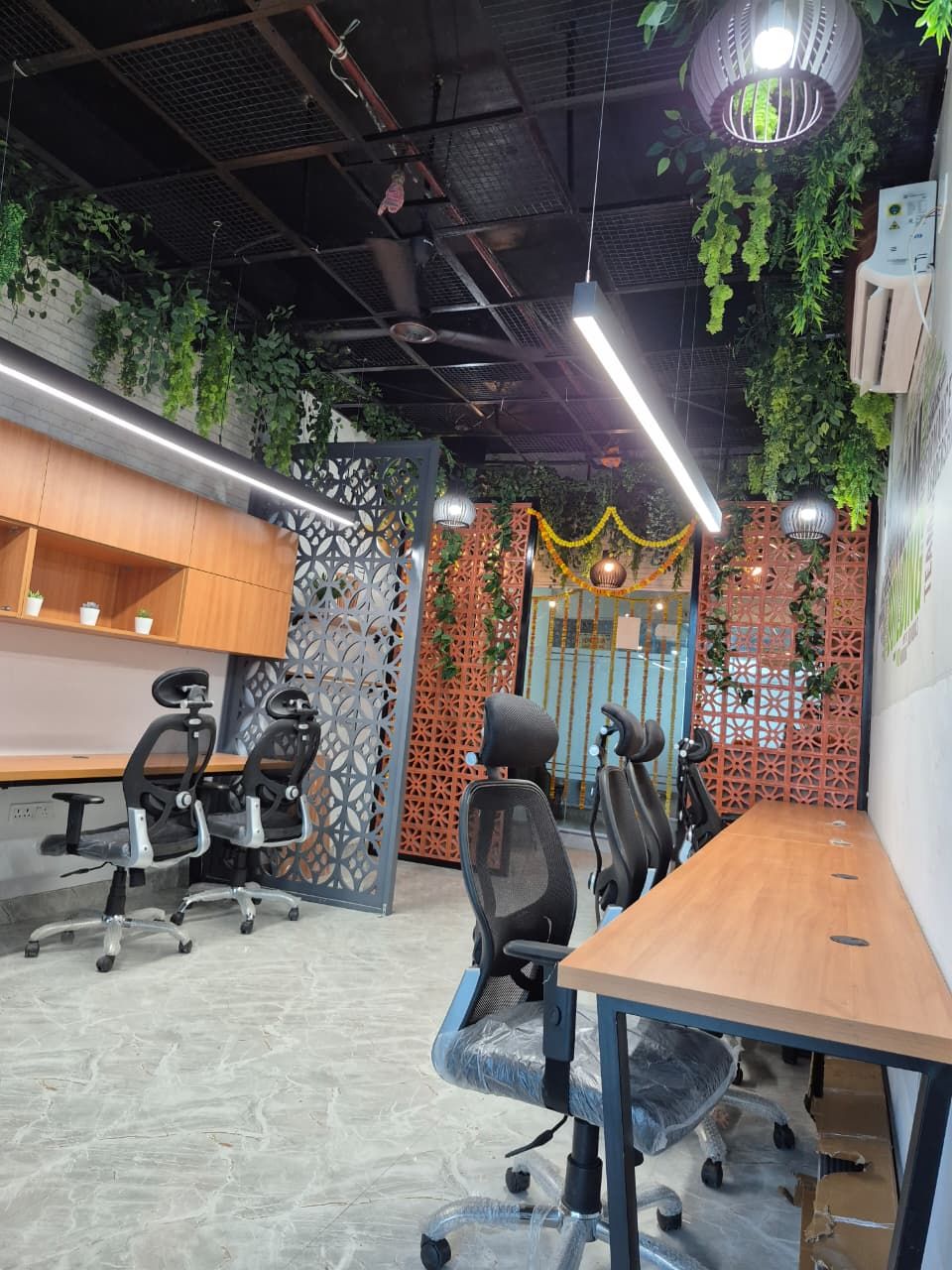 Workstations beside a full-height glass partition wall