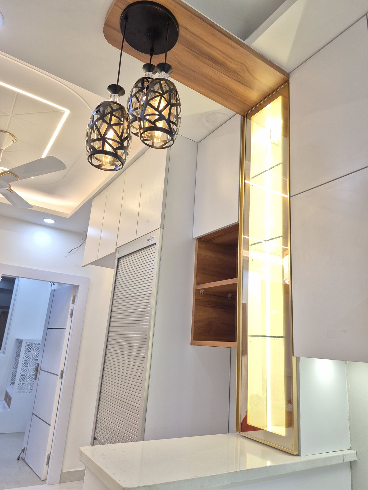 Bedroom with recessed cove lighting and a wall-mounted media console