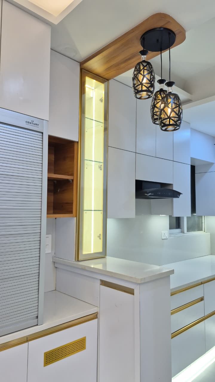 L-shaped modular kitchen with wall tiling and continuous counter lighting